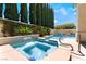 Inviting pool and spa area surrounded by mature trees and lush landscaping for privacy at 308 Kingsclear Ct, Las Vegas, NV 89145