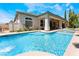 A refreshing backyard pool with an adjacent covered patio, perfect for outdoor entertaining and relaxation at 308 Kingsclear Ct, Las Vegas, NV 89145