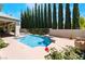Sparkling pool and spa with a waterfall feature, set amidst a beautifully landscaped backyard at 308 Kingsclear Ct, Las Vegas, NV 89145