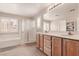 Bathroom with double sinks, a glass shower, and window with shutters at 3141 Monet Sunrise Ave, Henderson, NV 89044