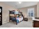 Comfortable bedroom with a bunk bed, window with shutters and neutral wall paint at 3141 Monet Sunrise Ave, Henderson, NV 89044