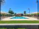 Beautiful community pool area with ample lounge chairs, umbrellas, and well-manicured landscaping for residents enjoyment at 3141 Monet Sunrise Ave, Henderson, NV 89044