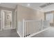 Upstairs hallway features white railing and a view of a window with shutters at 3141 Monet Sunrise Ave, Henderson, NV 89044