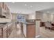 Bright kitchen showcasing wood cabinets, an island, and dining area, offering a practical living space at 3141 Monet Sunrise Ave, Henderson, NV 89044