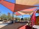 Community playground with modern shade canopies, play structures, and seating under a clear blue sky at 3141 Monet Sunrise Ave, Henderson, NV 89044