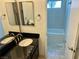 Bathroom featuring a black vanity and mirror next to a tub/shower combo at 3144 Downing Pl, Las Vegas, NV 89121