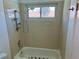 Shower and tub with tile surround, window, and updated fixtures at 3144 Downing Pl, Las Vegas, NV 89121