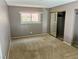 Comfortable bedroom with carpeted floors, a mirrored closet, and a bright window at 3144 Downing Pl, Las Vegas, NV 89121
