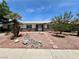 Inviting single-story home with desert-style landscaping and a decorative rock pathway at 3144 Downing Pl, Las Vegas, NV 89121