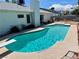 Sparkling pool with diving board is surrounded by concrete in this spacious backyard at 3144 Downing Pl, Las Vegas, NV 89121