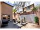 Backyard patio area with outdoor seating, fire pit, grill, and string lights perfect for entertaining at 3367 Popcorn Flower St, Las Vegas, NV 89117