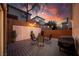 Cozy backyard featuring a wooden deck, seating area, privacy screen, and ambient string lights at 3367 Popcorn Flower St, Las Vegas, NV 89117