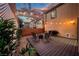 Outdoor patio with seating area and barbecue under string lights, perfect for evening relaxation at 3367 Popcorn Flower St, Las Vegas, NV 89117