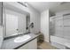 Stylish bathroom featuring a large mirror, granite countertop, and shower over tub at 3367 Popcorn Flower St, Las Vegas, NV 89117