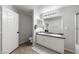 Bathroom featuring double sinks with white cabinets, modern lighting, and shower over tub at 3367 Popcorn Flower St, Las Vegas, NV 89117