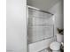 Bright bathroom with a sliding glass shower door, modern fixtures, and clean white finishes at 3367 Popcorn Flower St, Las Vegas, NV 89117
