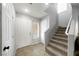 Cozy front foyer area with modern vinyl flooring, a staircase, and natural light through a window at 3367 Popcorn Flower St, Las Vegas, NV 89117