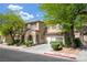 Inviting two-story home with well-manicured landscaping, a charming front porch, and an attached garage at 3367 Popcorn Flower St, Las Vegas, NV 89117