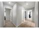 Carpeted hallway with doors leading to multiple rooms with neutral paint throughout the home at 3367 Popcorn Flower St, Las Vegas, NV 89117