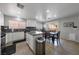 Open floorplan with kitchen island, stainless appliances, dining area and a view into the living room at 3367 Popcorn Flower St, Las Vegas, NV 89117