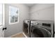 Convenient laundry room featuring side by side washer and dryer, and window to allow natural light at 3367 Popcorn Flower St, Las Vegas, NV 89117