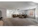 Neutral toned living room with plush carpet, ceiling fan and comfortable sofas at 3367 Popcorn Flower St, Las Vegas, NV 89117