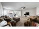Cozy living room features plush carpet, ceiling fan, and flows seamlessly into the kitchen and dining area at 3367 Popcorn Flower St, Las Vegas, NV 89117