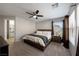 Main bedroom suite with ceiling fan, side tables, carpet flooring, and an ensuite bathroom at 3367 Popcorn Flower St, Las Vegas, NV 89117