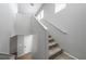 Carpeted staircase with white handrail leads to upper level with multiple windows for ample natural light at 3367 Popcorn Flower St, Las Vegas, NV 89117