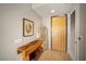 Inviting entryway with a wooden console table, stylish artwork, and a full-length mirror at 353 E Bonneville Ave # 215, Las Vegas, NV 89101