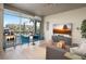 Modern living room with large windows, stylish furniture, and a view of the city at 353 E Bonneville Ave # 215, Las Vegas, NV 89101
