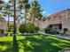 Condo complex featuring manicured lawns and mature trees and desert landscaping at 3750 Desert Marina Dr # 37, Laughlin, NV 89029