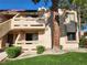 Two-story condo exterior featuring private balconies, desert landscaping and mature trees at 3750 Desert Marina Dr # 37, Laughlin, NV 89029