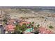The aerial shot showcases a view of the community pool and surrounding desert landscape with some buildings in the background at 3791 Desert Marina Dr # 109, Laughlin, NV 89029