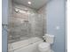 Bathroom with marble-tiled shower, glass door, toilet, and blue painted walls at 3791 Desert Marina Dr # 109, Laughlin, NV 89029