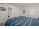 Bedroom with carpeted floors, a window with blinds, and white walls with artwork at 3791 Desert Marina Dr # 109, Laughlin, NV 89029