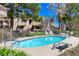 Relaxing community pool surrounded by mature trees and lounge chairs at 3791 Desert Marina Dr # 109, Laughlin, NV 89029