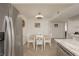 The dining area features a table with four chairs and stainless-steel refrigerator at 3791 Desert Marina Dr # 109, Laughlin, NV 89029
