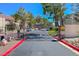 View of the gated entrance to the residences, with mature landscaping and guest parking at 3791 Desert Marina Dr # 109, Laughlin, NV 89029