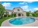 Backyard pool and covered patio surrounded by lush landscaping at 3846 Biltmore Bay St, Las Vegas, NV 89147