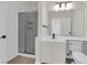 Bathroom featuring a shower with glass door, a large mirror, and white cabinets at 3846 Biltmore Bay St, Las Vegas, NV 89147