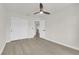 Bedroom featuring light wood-look flooring, neutral walls, ceiling fan, and closet with double doors at 3846 Biltmore Bay St, Las Vegas, NV 89147