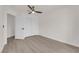 Bedroom featuring light wood-look flooring and closet with double doors, leading to a hallway at 3846 Biltmore Bay St, Las Vegas, NV 89147