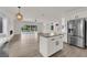 Island connects bright kitchen, open living space, and pool through sliding doors at 3846 Biltmore Bay St, Las Vegas, NV 89147