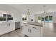 Open kitchen flows to living space and pool, boasting an island and stainless steel dishwasher at 3846 Biltmore Bay St, Las Vegas, NV 89147
