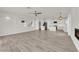 Bright open floor plan with hardwood floors connecting the living room, dining and kitchen areas at 3846 Biltmore Bay St, Las Vegas, NV 89147