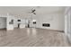 Open-concept living space with hardwood floors, fireplace and modern kitchen in the background at 3846 Biltmore Bay St, Las Vegas, NV 89147