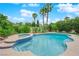 View of a sparkling swimming pool with a spa surrounded by lush landscaping at 3846 Biltmore Bay St, Las Vegas, NV 89147