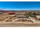 Elevated aerial view showcases the desert home and the South Point hotel in the distance at 4075 W Torino Ave, Las Vegas, NV 89139