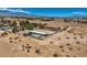 Wide aerial shot showcases desert property with outbuildings and desert landscaping at 4075 W Torino Ave, Las Vegas, NV 89139